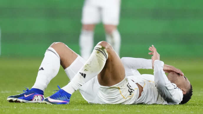 Kylian Mbappé receiving treatment on his knee during a training session.
