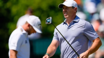 Rory McIlroy and Cameron Young walking the fairway at Augusta National during the third round.