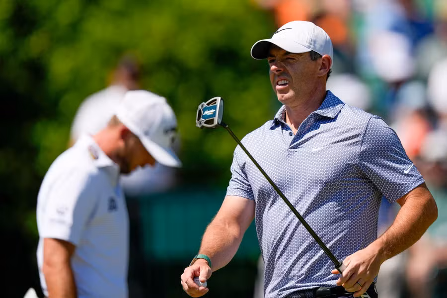 Rory McIlroy and Cameron Young walking the fairway at Augusta National during the third round.